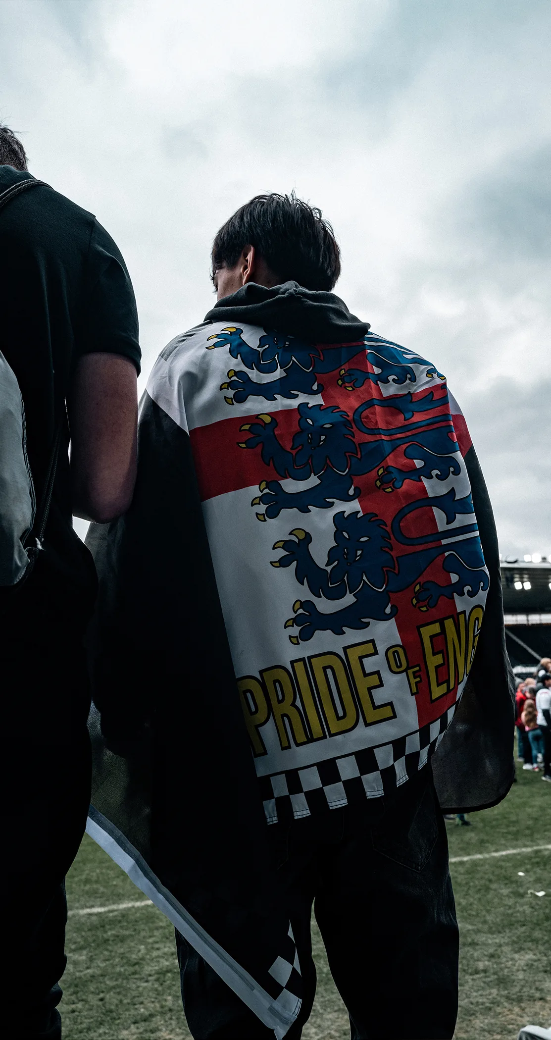 Fan wearing a Pride of England flag with three lions, Pride Park