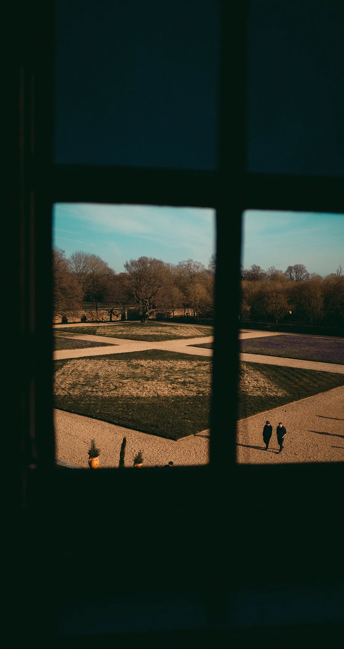 Formal parterre garden seen through a manor window, Sweden